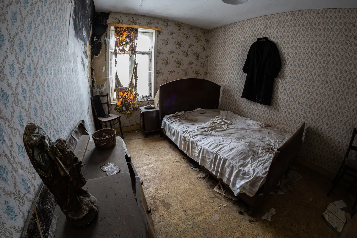 Bedroom with old furniture left behind in an empty house